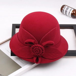 Close-up of deep red wool felt fedora with detailed 3D flower and bow decorations