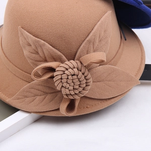 Detailed close-up of handmade floral accents on a brown wool fedora hat for women