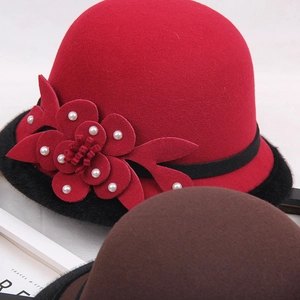Detail of wool felt hat featuring a 3D flower with pearls and black faux fur trim
