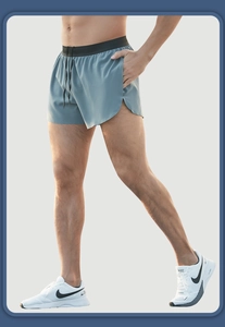 Macro detail of breathable mesh fabric and black elastic waistband on men's running shorts
