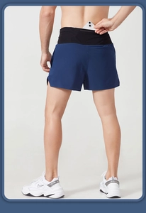 Detail view of the hidden rear waistband pocket on men's navy running shorts
