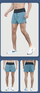 Detail of blue men's running shorts with black elastic waistband and side split design