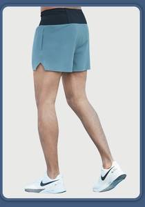 Detail of breathable mesh fabric on grey-blue running shorts with side split and elastic waist