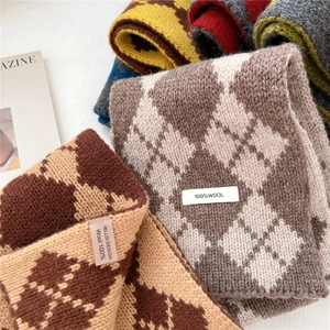 Close-up of 100% wool knit scarves featuring classic argyle patterns in various colors