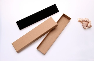 Top view of rectangular kraft paper jewelry box with black sponge liner and decorative shell