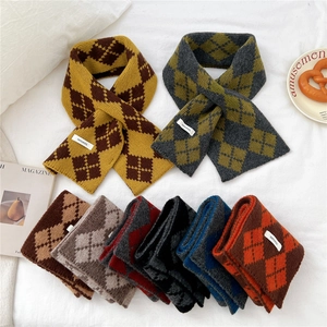 Detailed macro view showing the 100% pure wool labels and varied argyle knit patterns