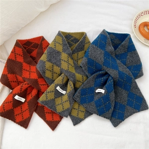 Detail showing soft argyle knit texture and wool tags of the cross-layer winter scarf