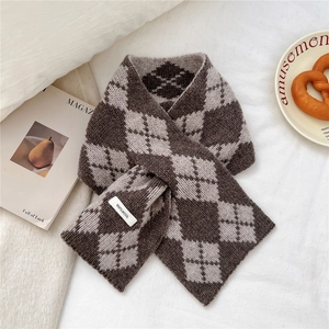 Detailed view of 100% wool knit scarf featuring a classic brown argyle diamond pattern