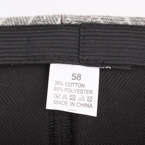 Retro plaid beret inner lining detail with composition label showing 35% cotton 65% polyester