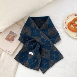 Detailed view of grey and blue diamond pattern knit scarf made from 100% pure wool