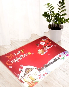Detail of Christmas doormat with Santa Claus and reindeer on a light wood floor
