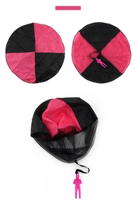 Detail view of pink and black tangle-free parachute toy with plastic soldier figure