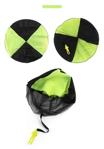 Detail view of large fluorescent green hand-thrown parachute toy with soldier model