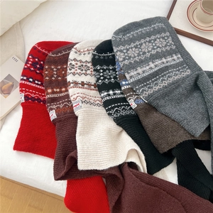 Detailed knit texture of Fair Isle pattern on balaclava hood scarf with woven label