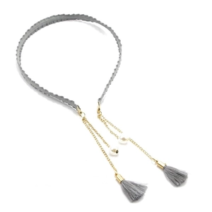 Detail of gray velvet headband with gold chains, faux pearls and fringe tassel accents