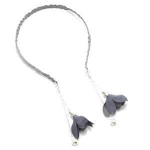 Detail of grey fabric headband featuring hanging metal chains with flower and pearl drops
