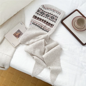 Close-up of beige knit balaclava scarf with vintage red and navy Fair Isle jacquard pattern