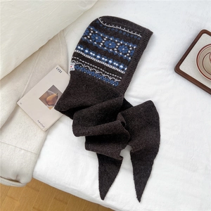 Detail of knit balaclava with Fair Isle pattern and long scarf in dark brown wool