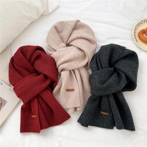 Chic solid knit scarves in red, beige and grey with leather patches for a cozy winter vibe