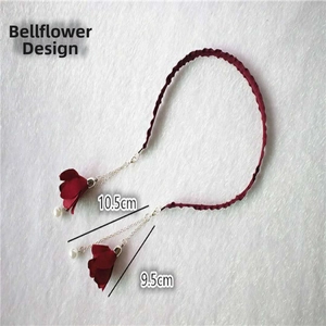 Detail view of red trumpet flower tassels with pearls and dimensions 10.5cm and 9.5cm