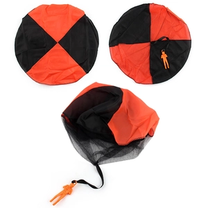 Large outdoor toy parachute with red and black canopy and orange soldier model figurine