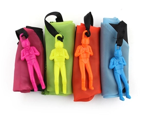 Close-up of four colorful plastic soldiers with nylon parachutes in pink, green, orange, and blue