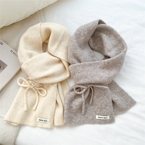 Soft knit bow scarf for women in cream and light brown colors with ribbed texture