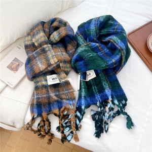 Detailed macro view of thick chunky knit striped scarf featuring long twisted tassel fringe