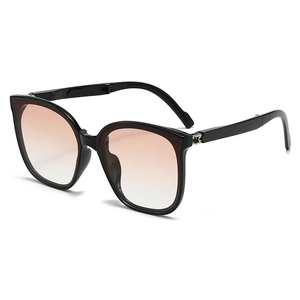 Chic black foldable cat-eye sunglasses with warm orange gradient lenses and metal hinges