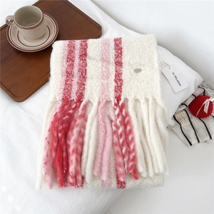 Macro detail of wool blend striped scarf showing knit texture and thick tassels