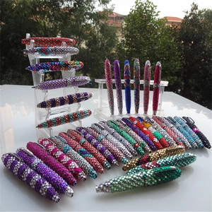 Detailed close-up of sparkling rhinestone-encrusted metal ballpoint pens in vibrant colors