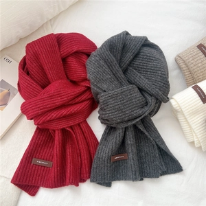Thick knitted ribbed scarf for women in multiple colors with stylish leather brand patch