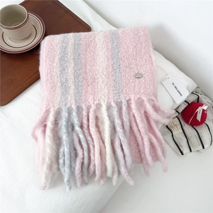 Detail of wool blend scarf featuring pink and blue stripes with thick tassel fringes