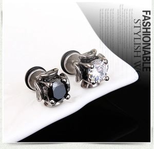 Macro shot of punk style stainless steel stud earrings with black and clear cubic zirconia