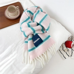 Detailed view of striped wool-blend scarf with long tassels and branded woven label