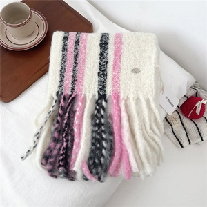 Close-up of wool blend fringe scarf with vertical stripes and soft knitted texture