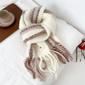 Close-up of wool blend striped scarf with long tassels and soft knitted texture details