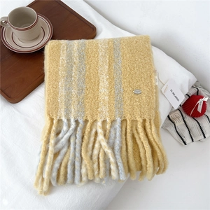 Detailed close-up of striped wool blend scarf with fringe tassels and metal brand tag