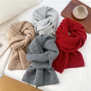 Thick knitted scarves in four colors with embroidered details for autumn and winter
