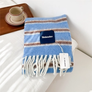 Detail of blue striped wool scarf with white tassels and Mulanduo brand label