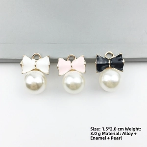 Detail view of bowknot pearl alloy charms in black white and pink for DIY jewelry