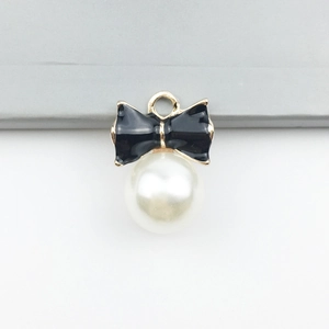 Elegant gold-framed black enamel bow pendant with a large pearl bead for DIY jewelry