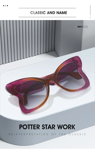 Macro detail of cat-eye sunglasses with purple gradient frames on a modern white pedestal