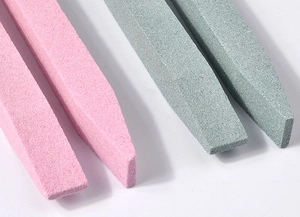 Macro detail of quartz nail file sticks for cuticle removal in pink and green