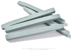 Macro detail of stacked gray quartz abrasive sticks for nail care and fine metal polishing