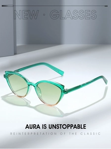 Cat eye sunglasses with green transparent TR90 frame and gradient lenses in a studio setting