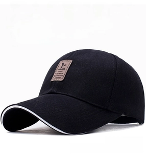 Close-up of black cotton baseball cap with EDIKO leather patch and white piping