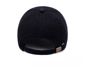 Adjustable back strap of a black cotton baseball cap with a classic brass metal buckle