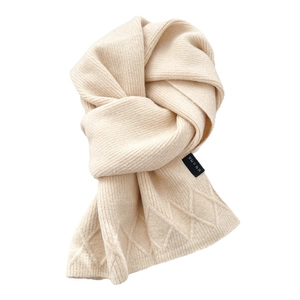Creamy beige argyle knit scarf with ribbed texture and minimalist diamond pattern