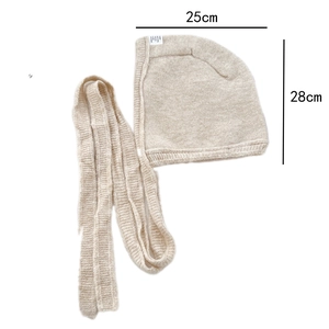 Detailed close-up of knitted ear flap hat showing 25cm width and 28cm height dimensions
